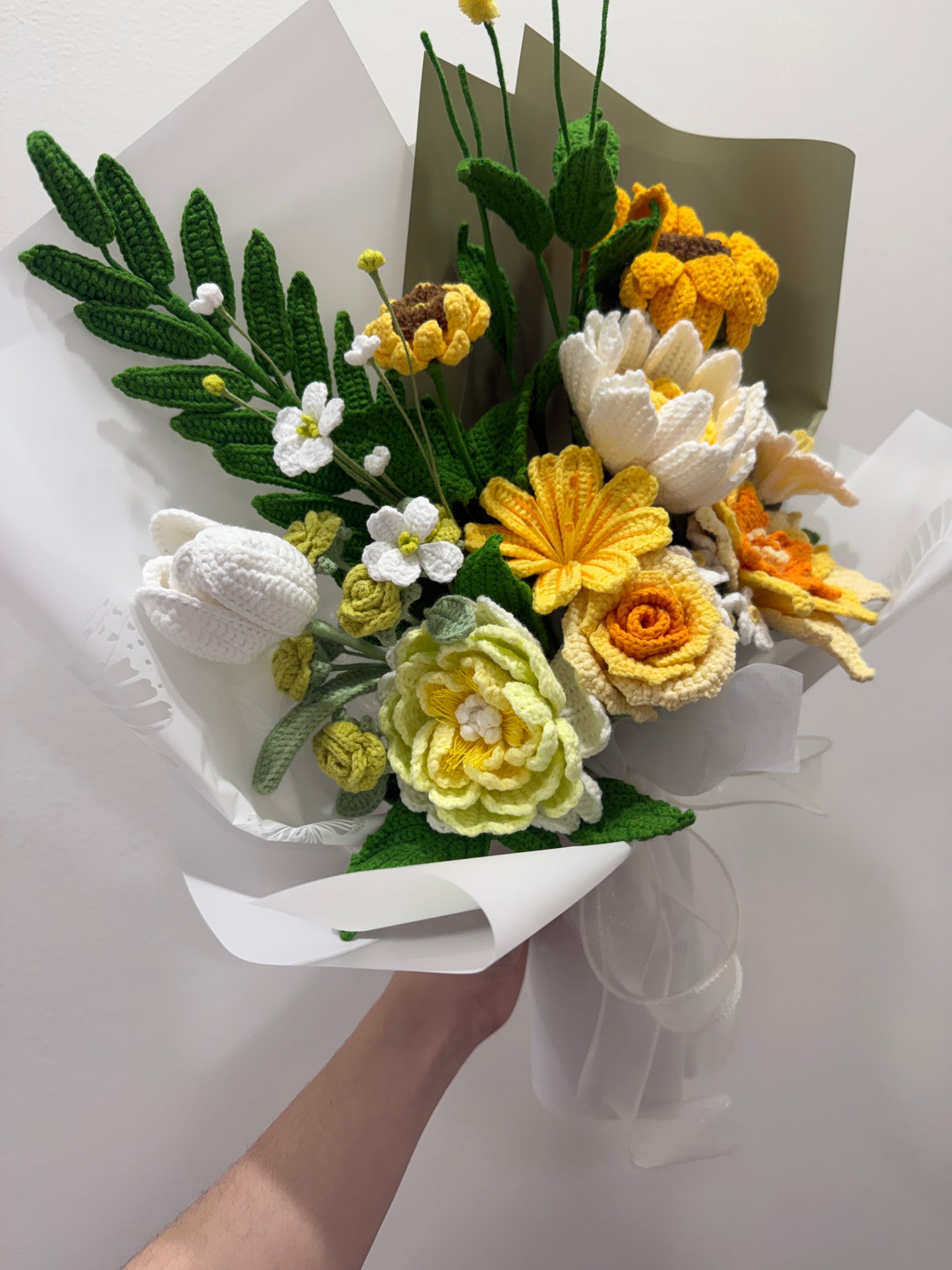 Bouquet of yellow, white, and green flowers on a white background