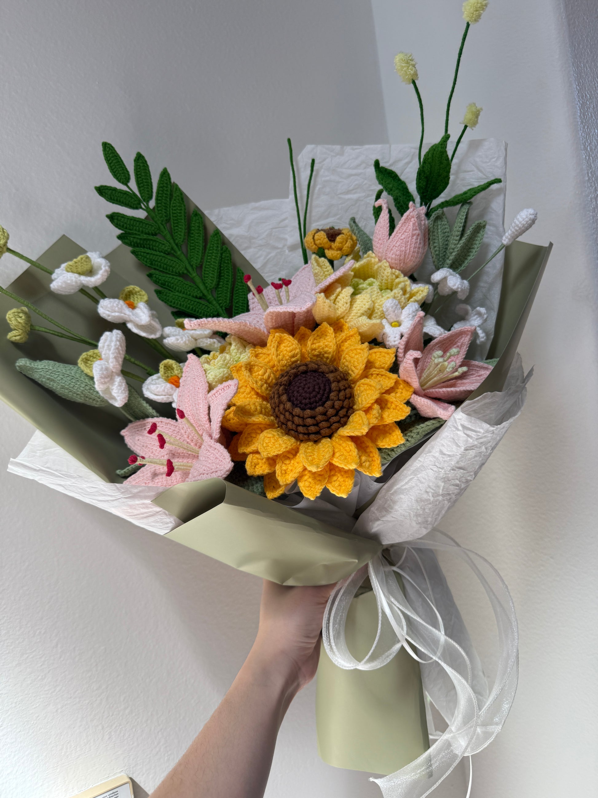 Bouquet of flowers with a sunflower and ribbons on a white background